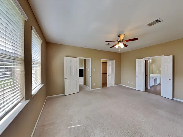 a view of a livingroom with a ceiling fan and window
