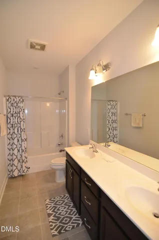 a bathroom with a sink a large mirror and a shower