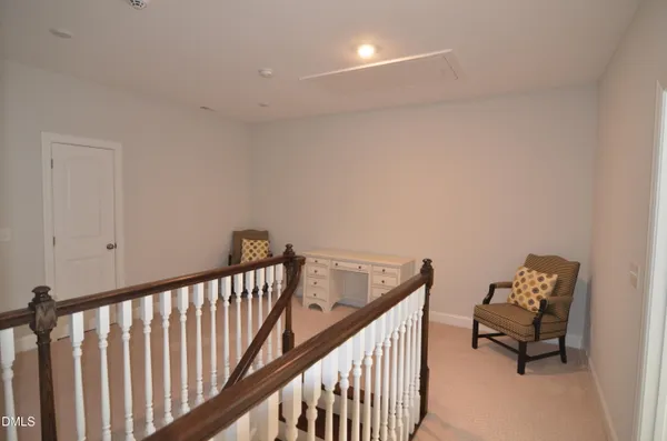 a view of a hallway with couch and dining table chair
