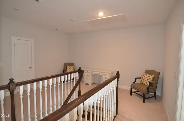 a view of a hallway with couch and dining table chair