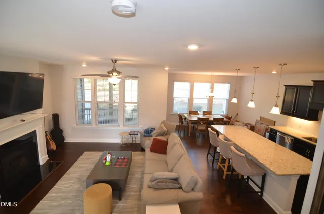 a living room with furniture flat screen tv and a fireplace