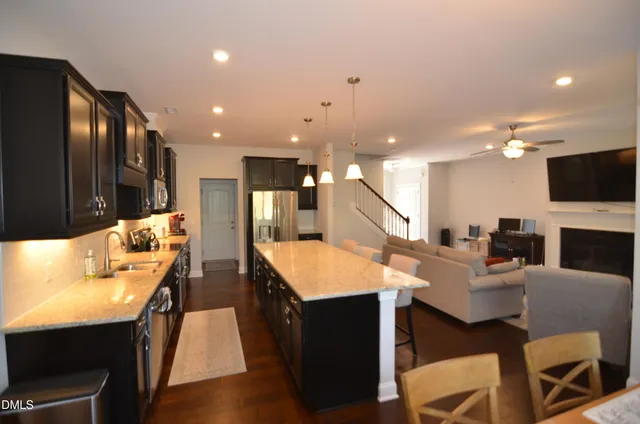 a large kitchen with a table and chairs