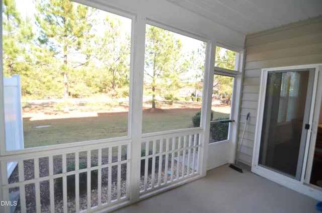 a view of a room with wooden floor and windows