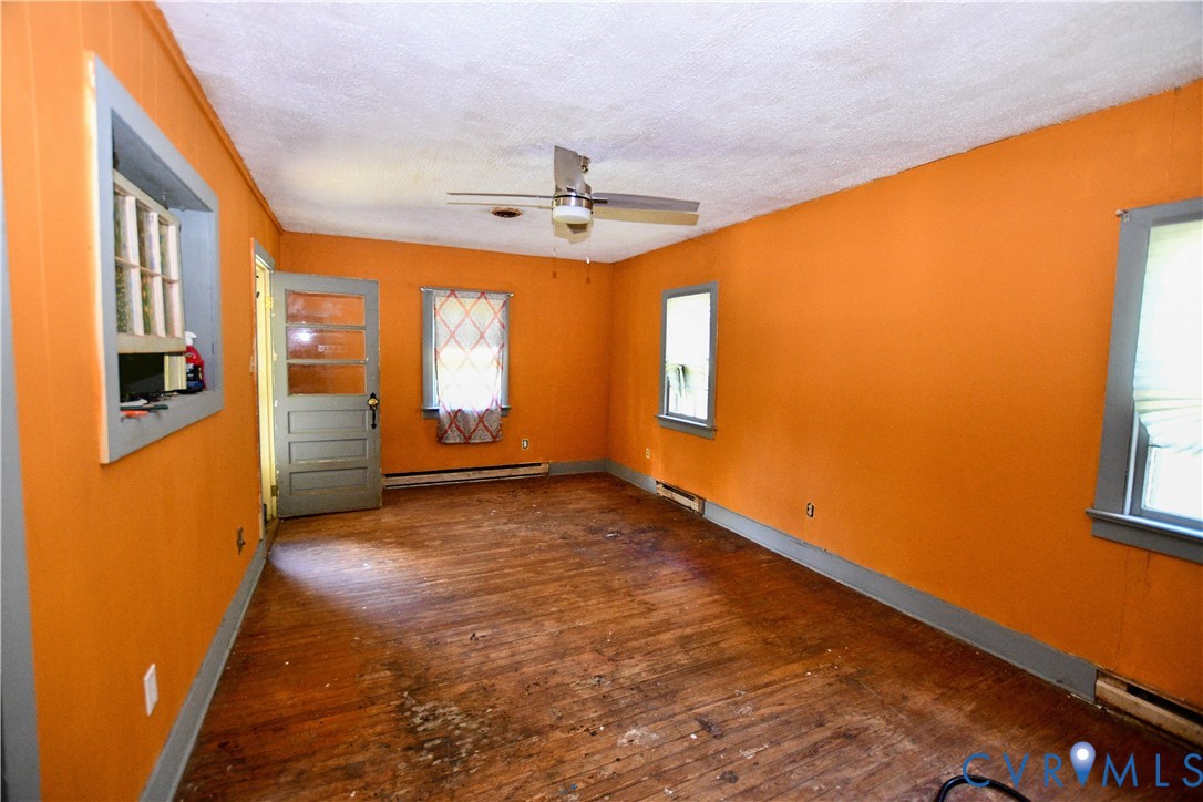 4856 Newtown Road St. Stephens Church, VA 23148 - Photo 3 of 11 Empty room with dark wood-style flooring, ceiling
