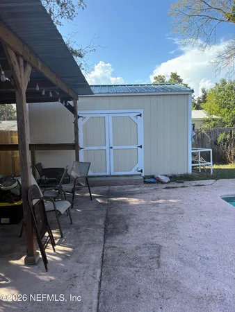 a view of a backyard with chair and a table
