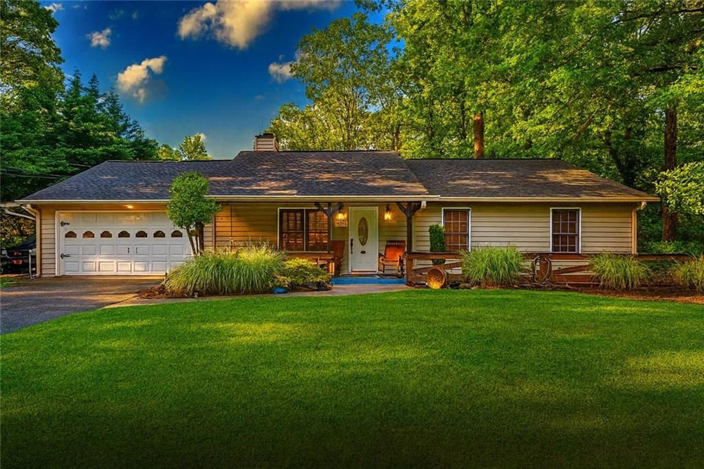a front view of a house with a garden