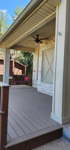 a view of a livingroom with a fireplace cabinet and windows