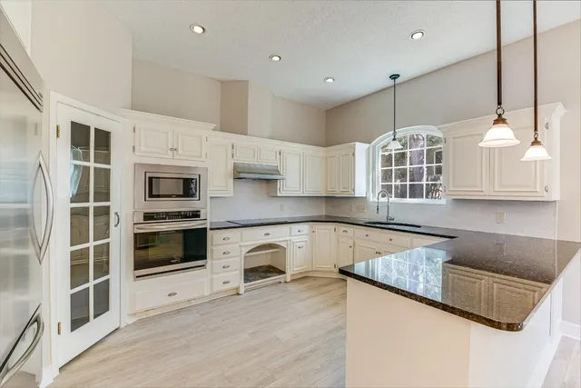 a kitchen with counter top space and stainless steel appliances