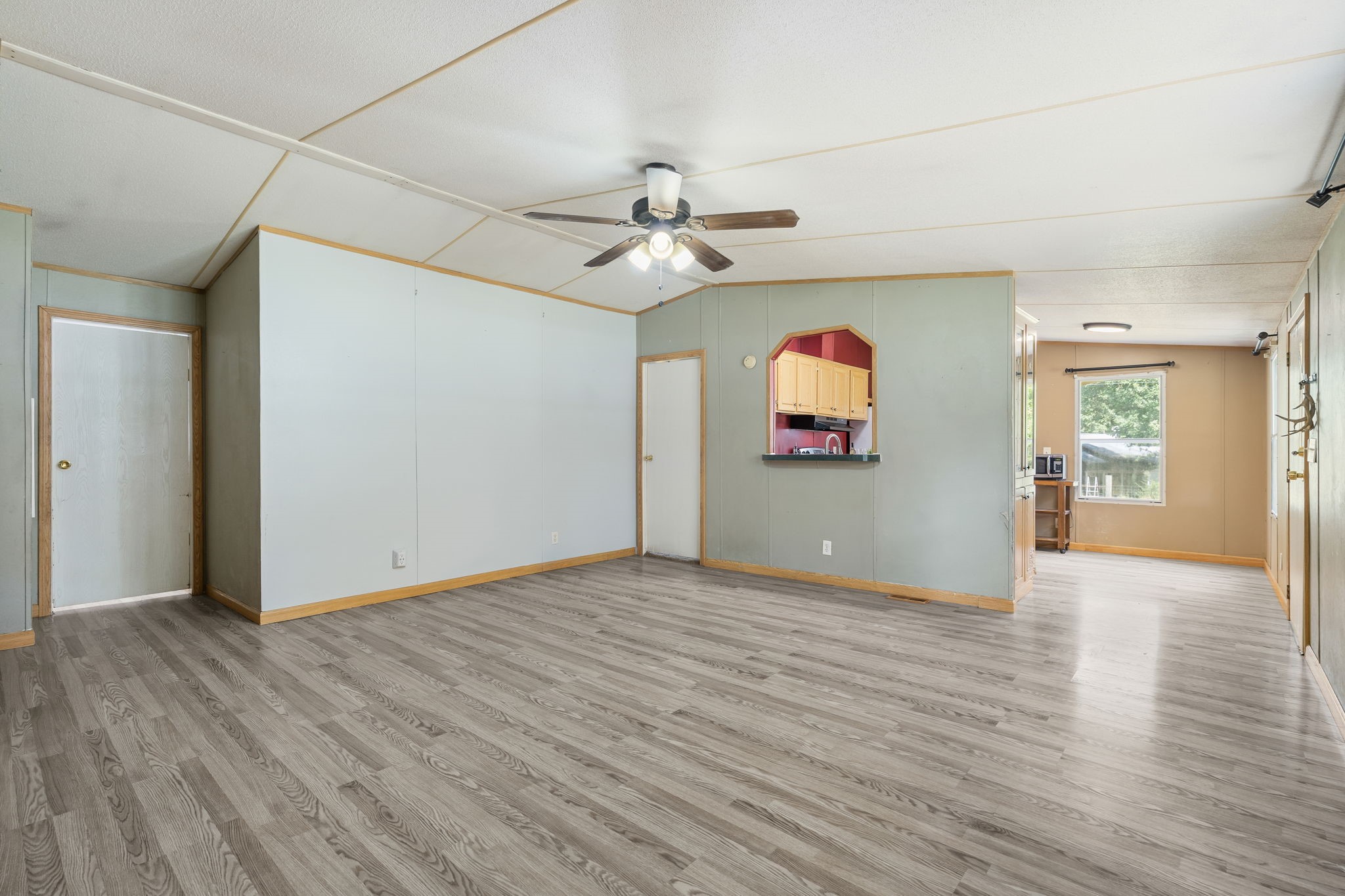 25003 Joseph Road Hockley, TX 77447 - Photo 11 of 47 an empty room with wooden floor chandelier fan and windows