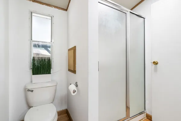 a bathroom with a toilet and a shower