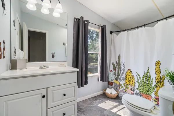a bathroom with a sink mirror and toilet