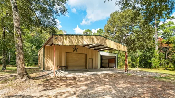 a view of a house with a yard and large tree