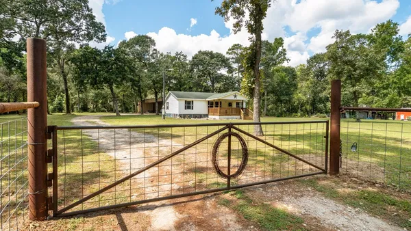 a view of a house with backyard and deck