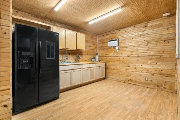 a kitchen with a refrigerator and a sink