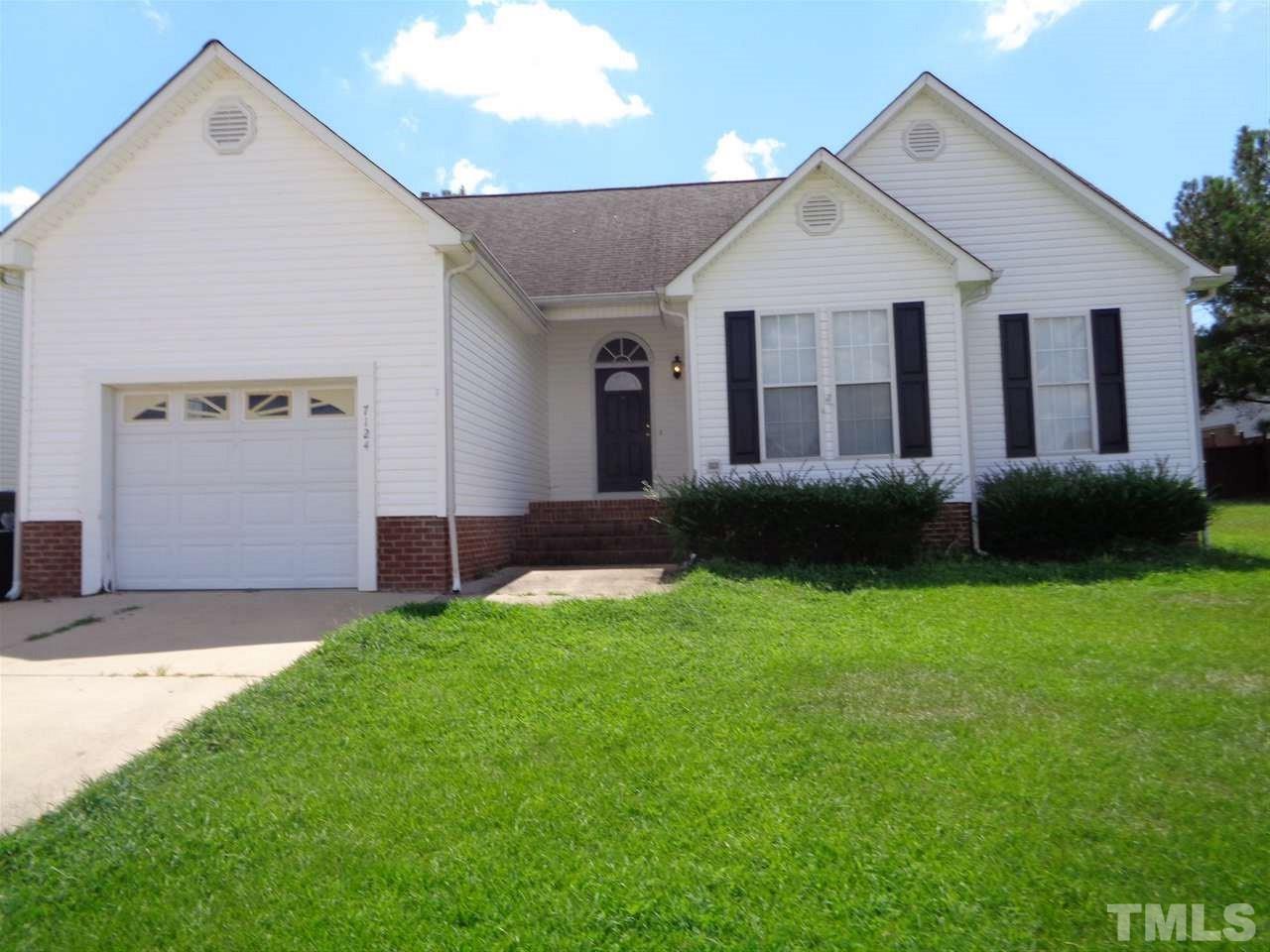 7124 Spanglers Spring Way Raleigh, NC 27610 - Photo 1 of 10 a front view of a house with garden
