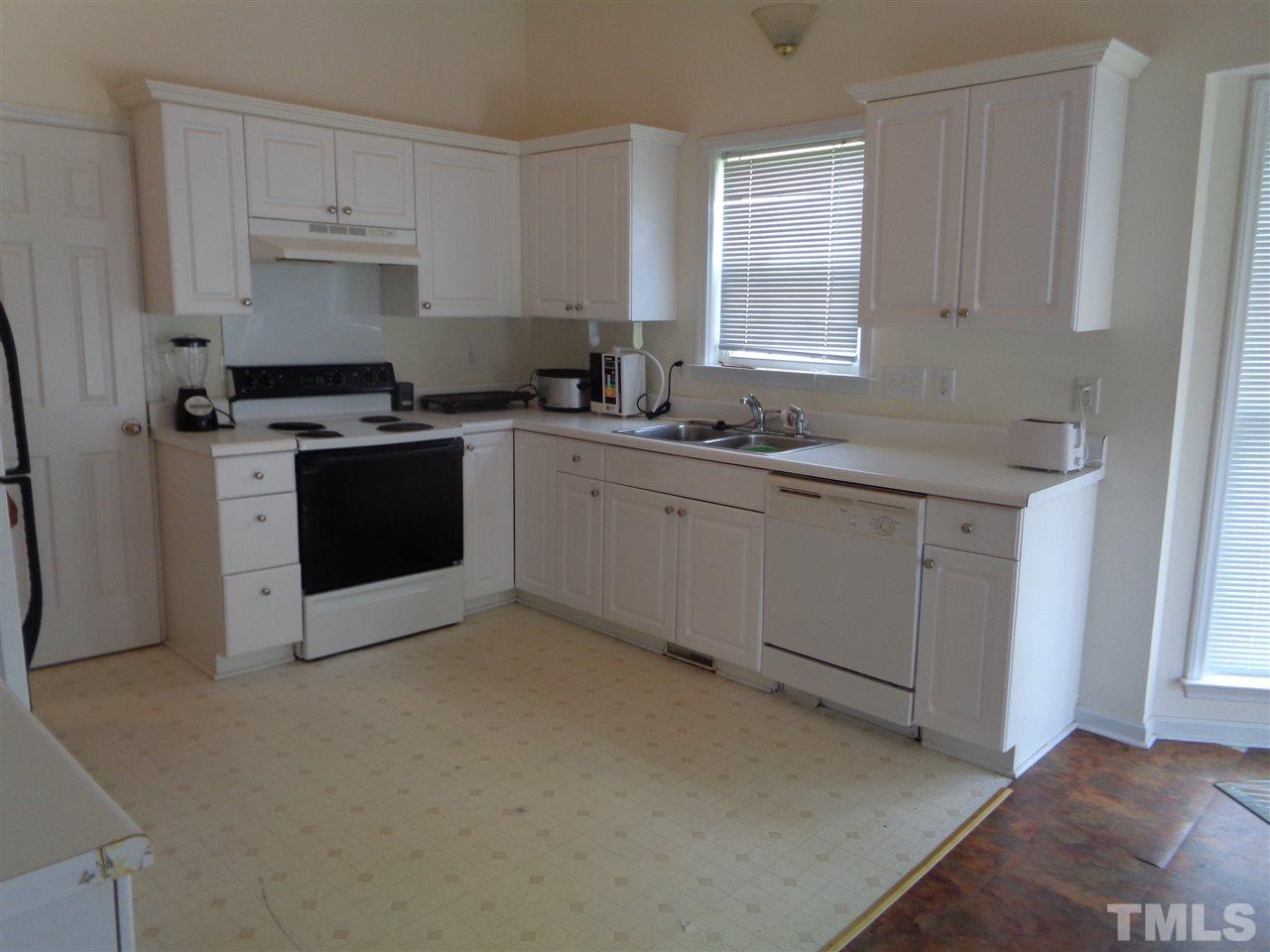7124 Spanglers Spring Way Raleigh, NC 27610 - Photo 2 of 10 a kitchen with stainless steel appliances granite countertop a stove a sink and a refrigerator