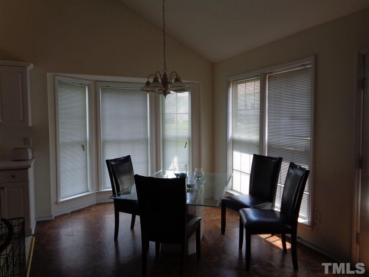 7124 Spanglers Spring Way Raleigh, NC 27610 - Photo 4 of 10 a view of a dining room with furniture and wooden floor