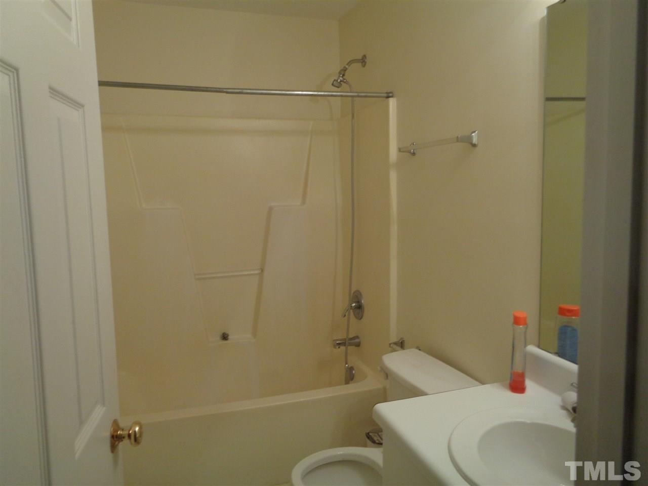 7124 Spanglers Spring Way Raleigh, NC 27610 - Photo 9 of 10 a bathroom with a toilet and a shower