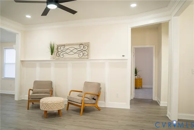 a view of a hallway with wooden floor and furniture