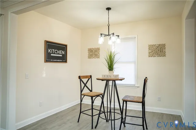 a view of a dining room with furniture and a chandelier