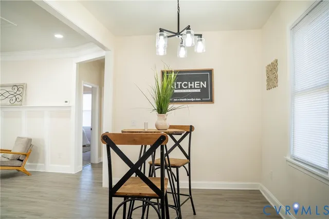 a view of a dining room with furniture and wooden floor