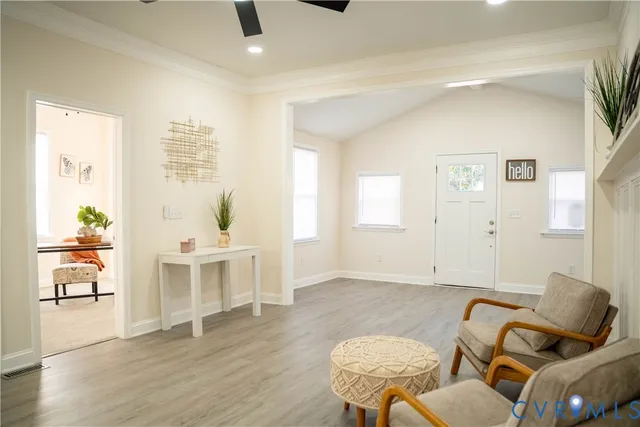 a living room with furniture and wooden floor
