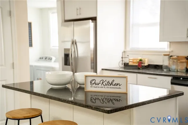 a kitchen with a refrigerator and cabinets
