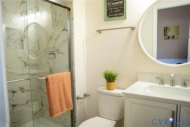 a bathroom with a sink and mirror with toilet