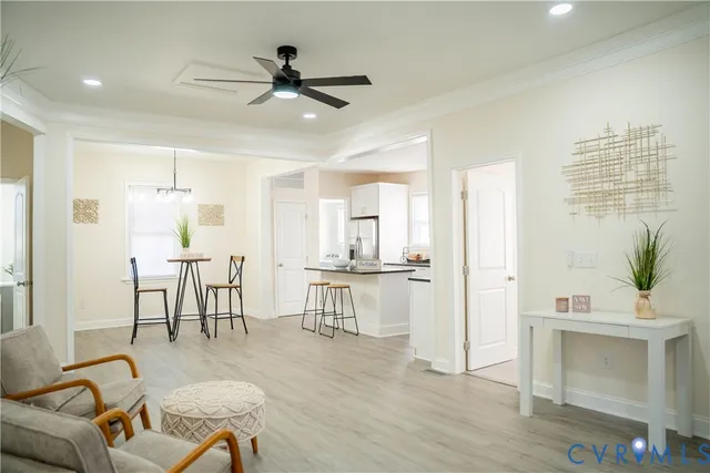 a living room with furniture a dining table and a fireplace
