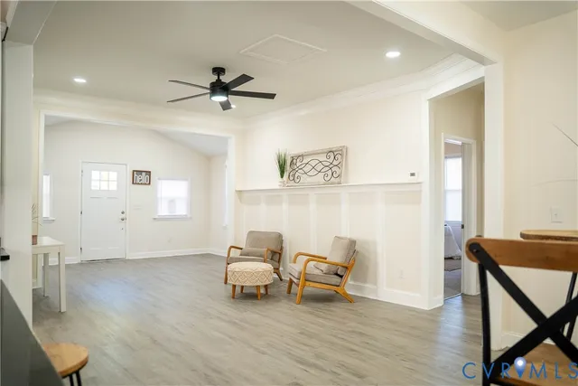 a living room with furniture and a wooden floor