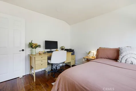a bedroom with two beds and a chair