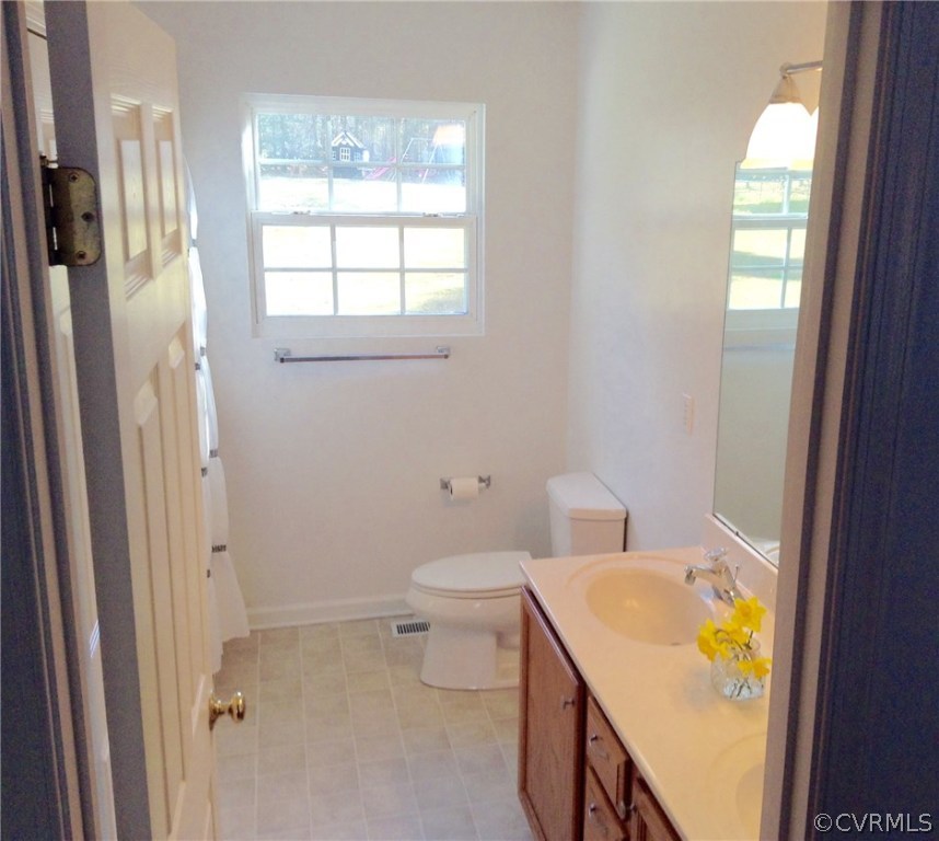 4810 Venable Road Kents Store, VA 23084 - Photo 15 of 22 a bathroom with a granite countertop toilet and a sink