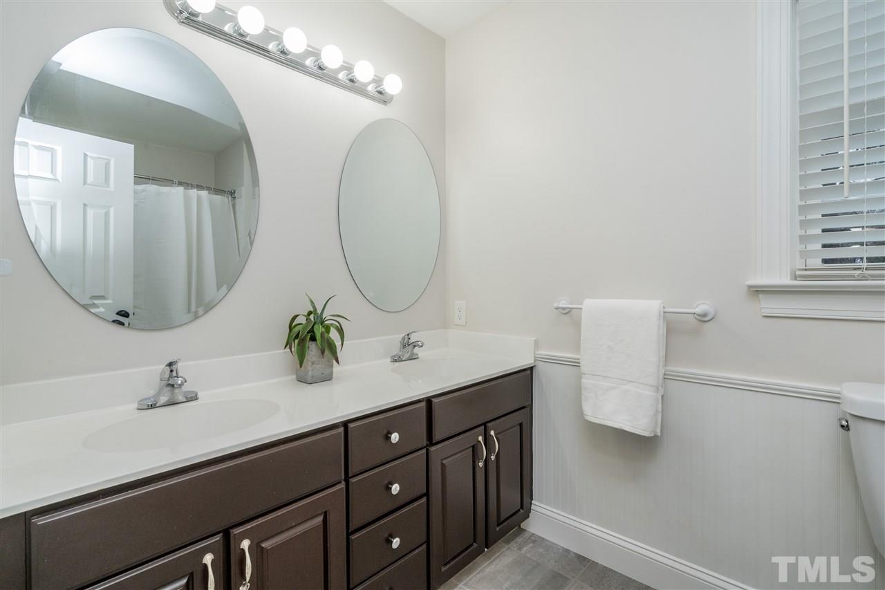 6916 Darcy Lane Raleigh, NC 27606 - Photo 20 of 30 Secondary bath, updated tile, dual sinks.