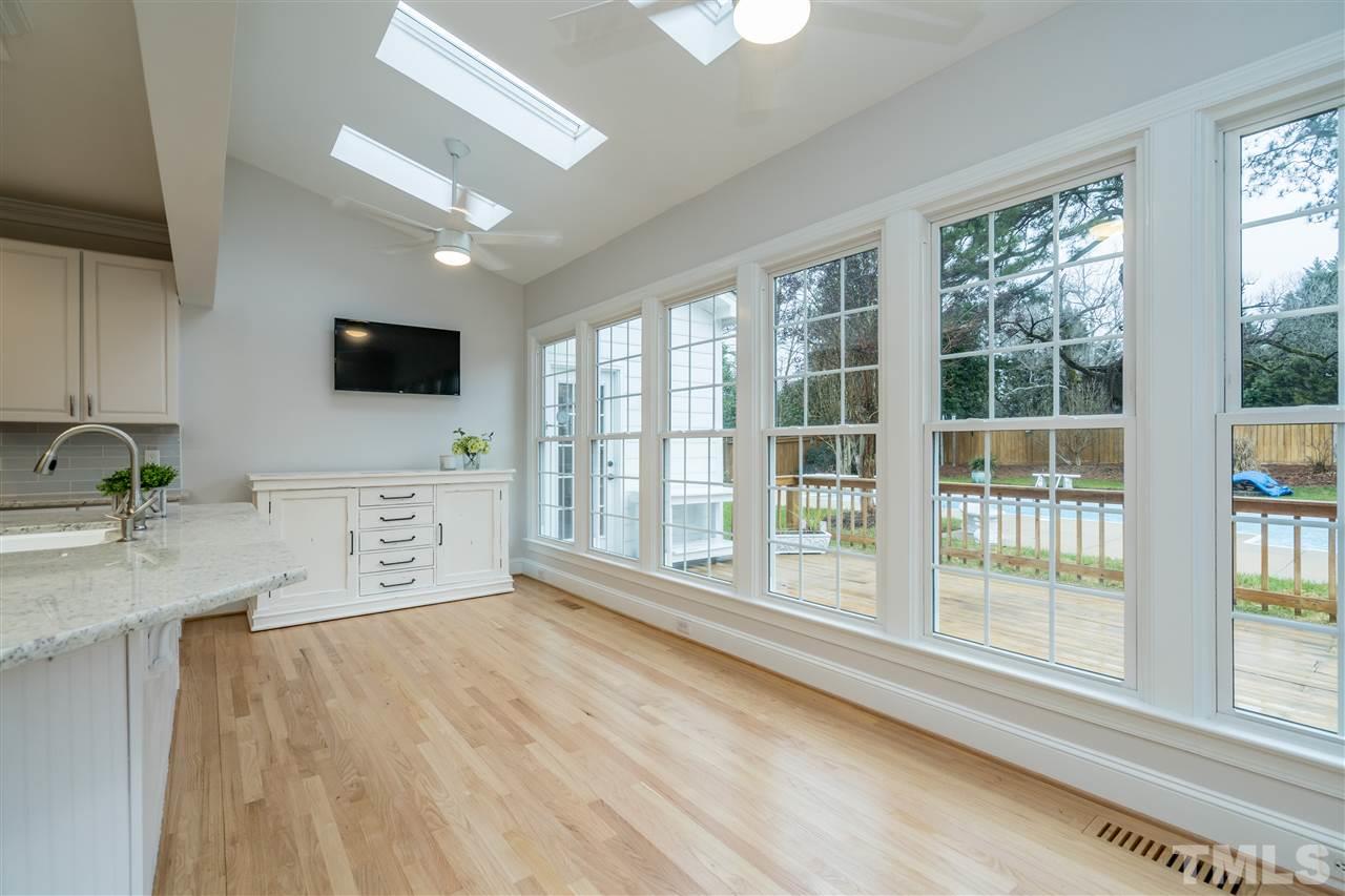 6916 Darcy Lane Raleigh, NC 27606 - Photo 10 of 30 Huge eat in kitchen space with skylights and new lighting.