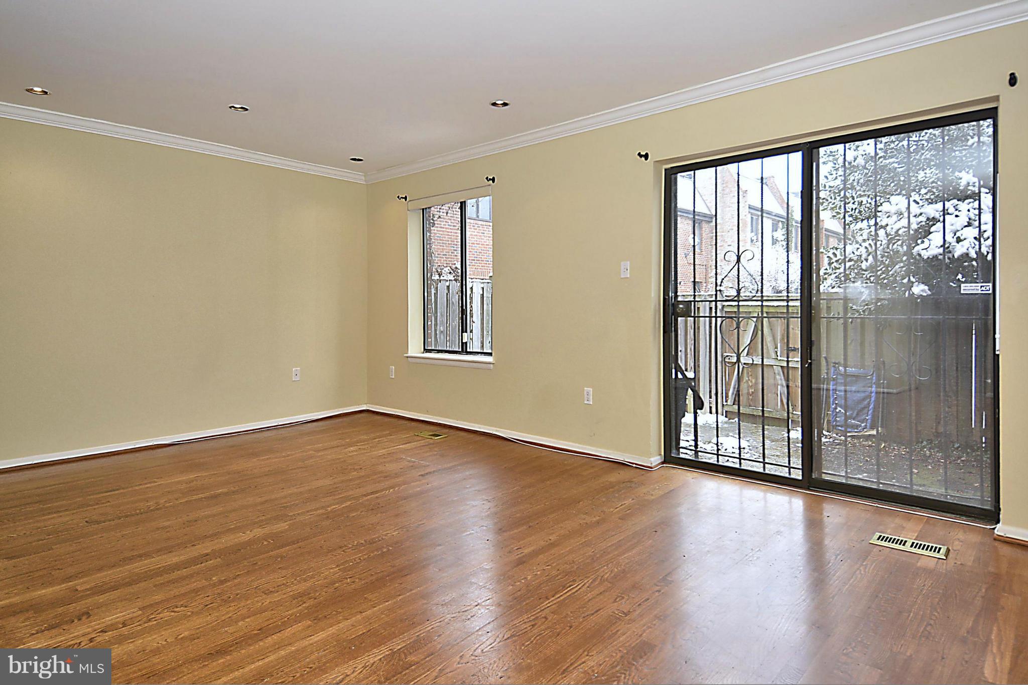 7421 Blair Road Northwest, Unit 7421 Washington, DC 20012 - Photo 12 of 27 a view of an empty room with wooden floor and a window