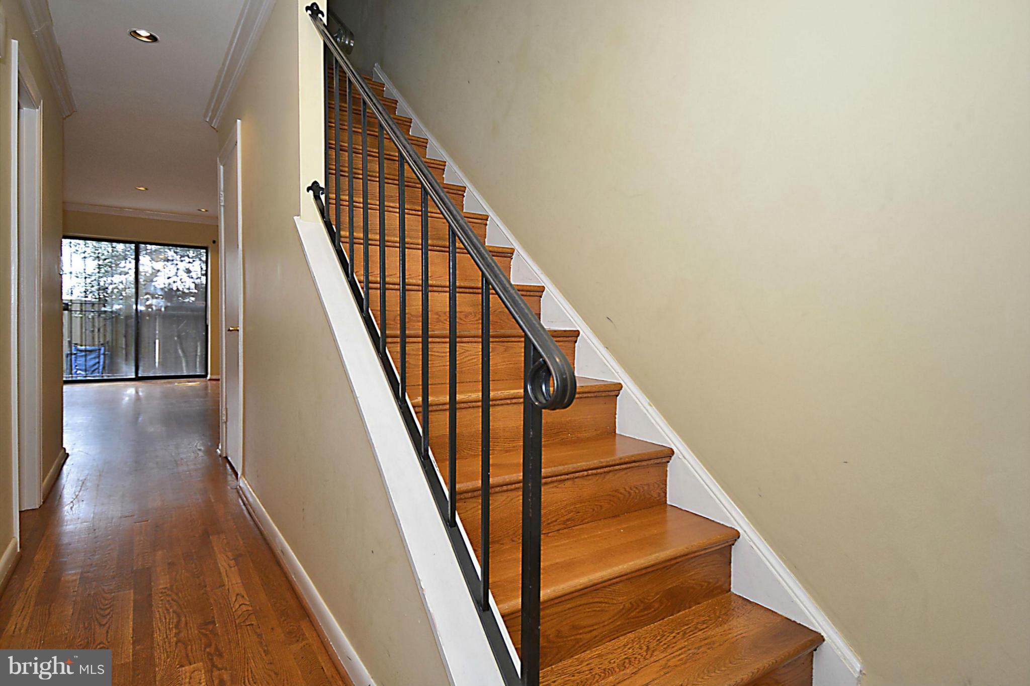 7421 Blair Road Northwest, Unit 7421 Washington, DC 20012 - Photo 15 of 27 a view of staircase with wooden floor and white walls
