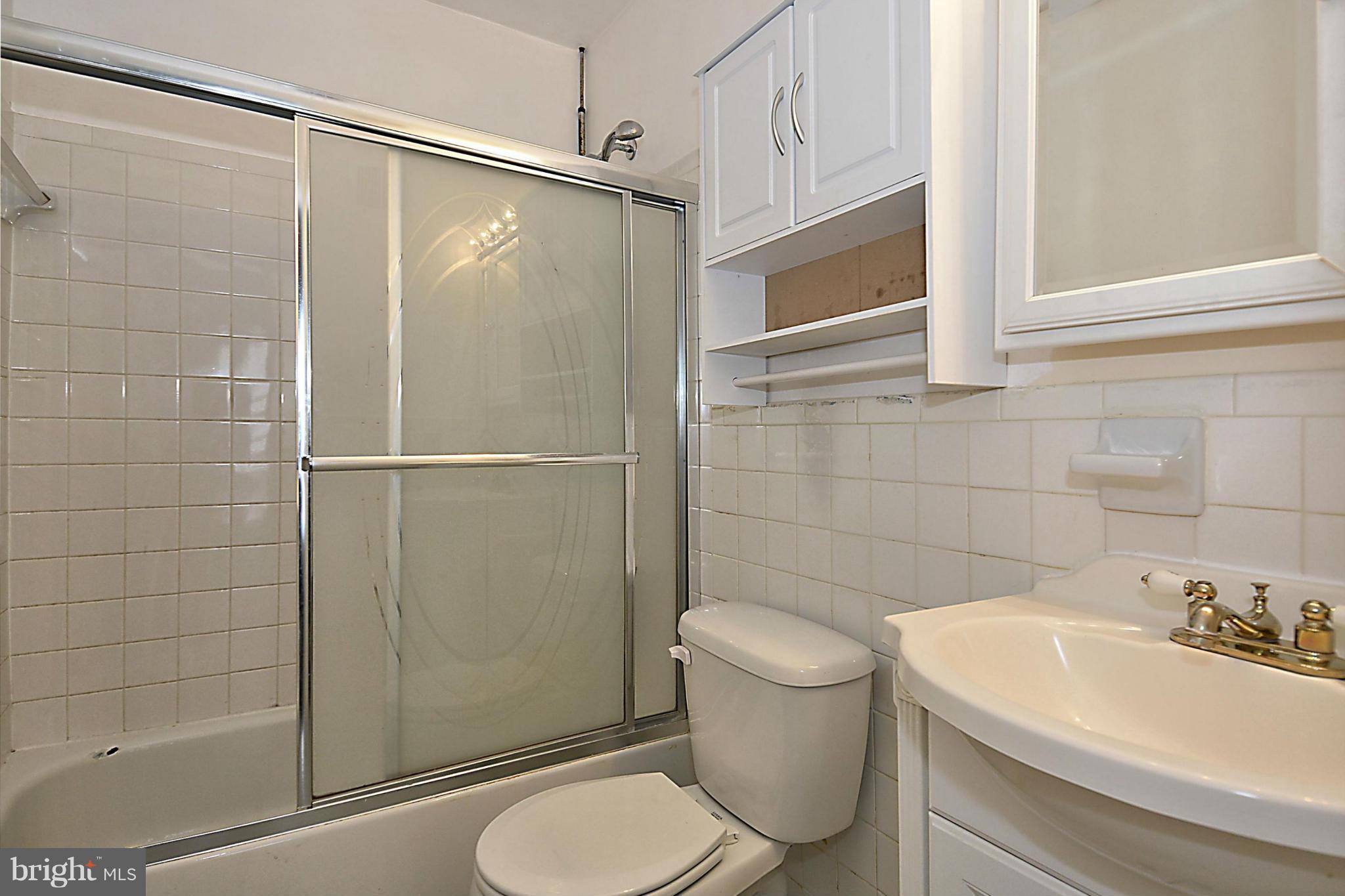 7421 Blair Road Northwest, Unit 7421 Washington, DC 20012 - Photo 18 of 27 a bathroom with a sink a toilet and shower