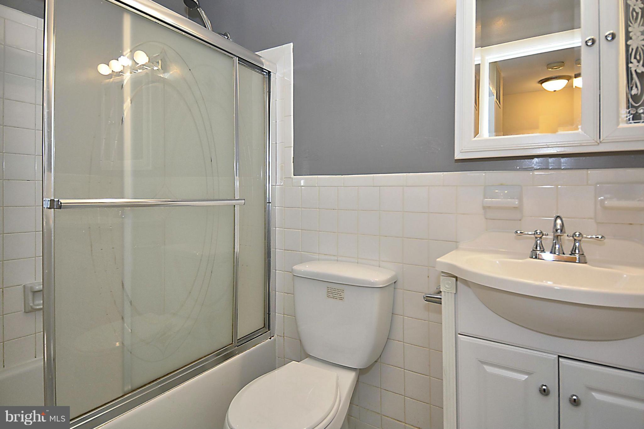 7421 Blair Road Northwest, Unit 7421 Washington, DC 20012 - Photo 21 of 27 a bathroom with a sink a toilet and shower