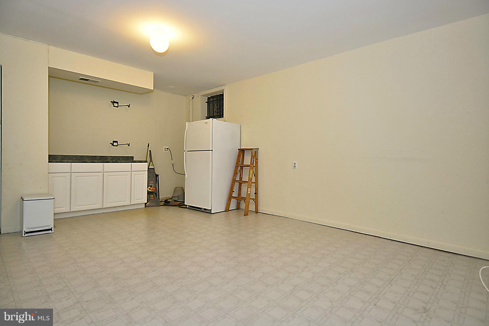 7421 Blair Road Northwest, Unit 7421 Washington, DC 20012 - Photo 25 of 27 a view of a room with refrigerator and white cabinets