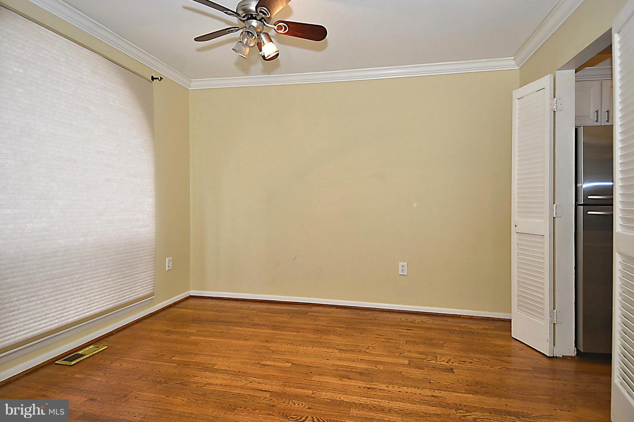 7421 Blair Road Northwest, Unit 7421 Washington, DC 20012 - Photo 9 of 27 a view of room with hardwood floor and ceiling fan