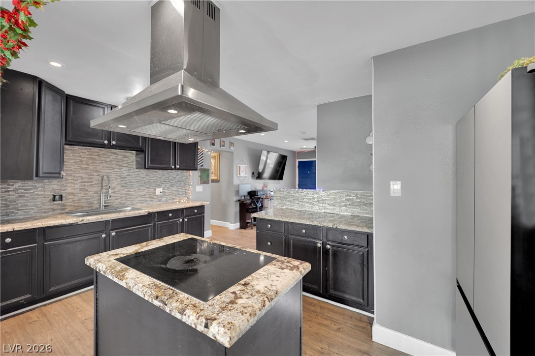 2221 Englestad Street North Las Vegas, NV 89030 - Photo 10 of 32 A sleek kitchen island cooktop provides a central culinary workspace.