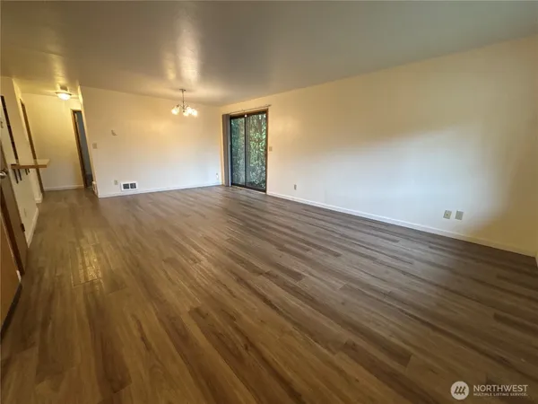 a view of an empty room and wooden floor