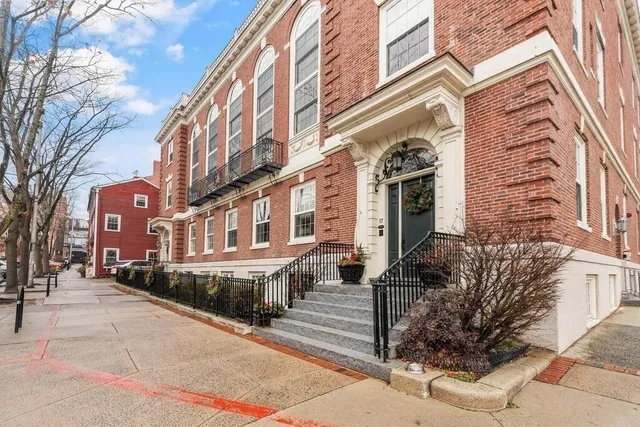 a front view of a brick building with many windows