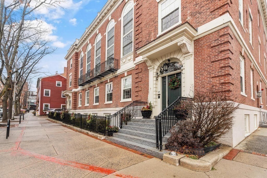 a front view of a brick building with many windows