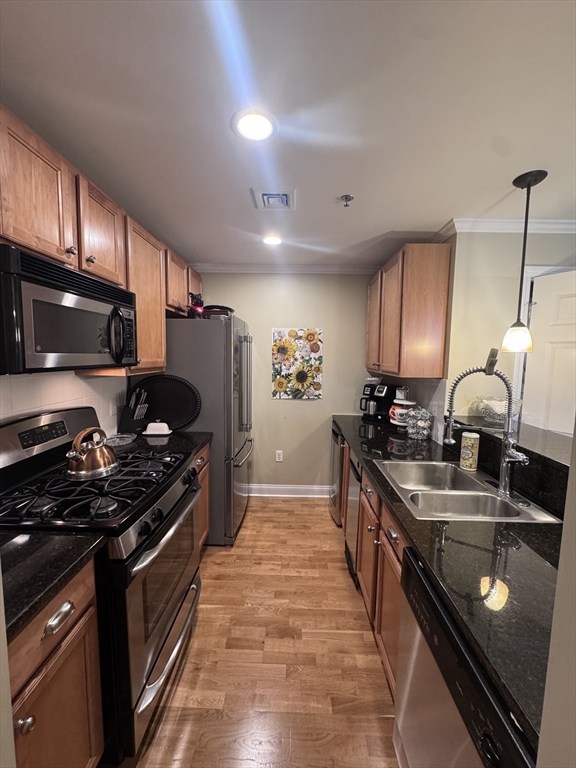 17 Central Street, Unit 9 Salem, MA 01970 - Photo 11 of 13 a kitchen with stainless steel appliances a sink a stove and cabinets