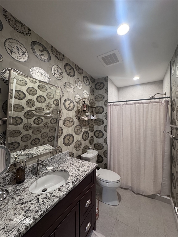 17 Central Street, Unit 9 Salem, MA 01970 - Photo 13 of 13 a bathroom with a granite countertop sink toilet and shower curtain