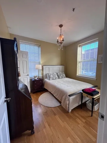 a bedroom with a bed dresser and a window