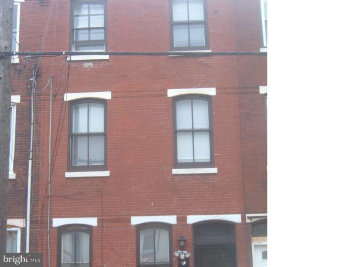a brick building with a window and a door