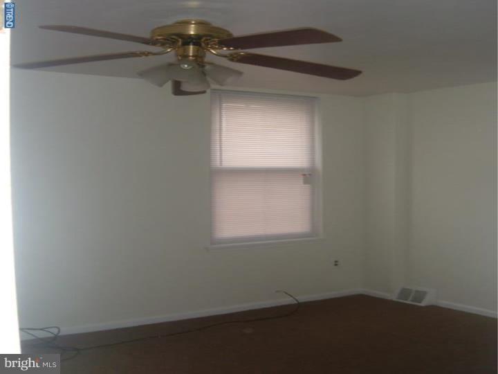 3936 Spring Garden Street Philadelphia, PA 19104 - Photo 7 of 7 a view of a small space with wooden floor and a window