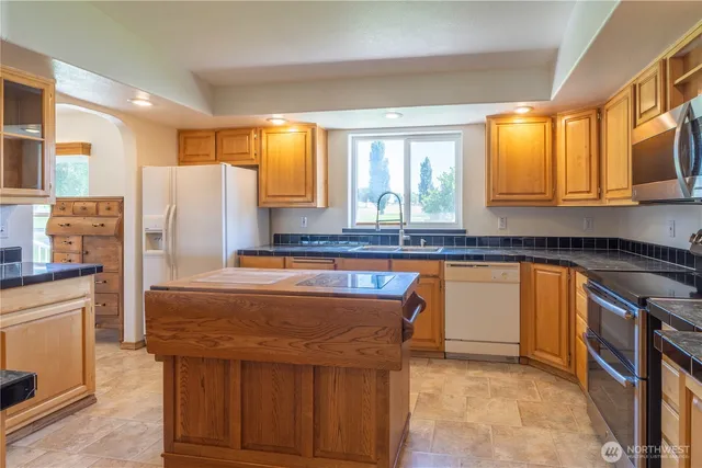 a kitchen that has a stove and a table in it
